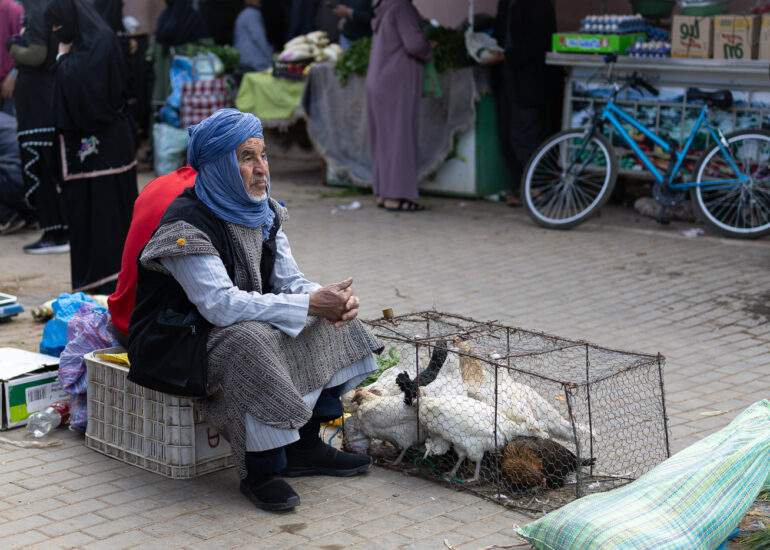 An Amazigh chicken vendor at a souk in the Anti-Atlas Mountains