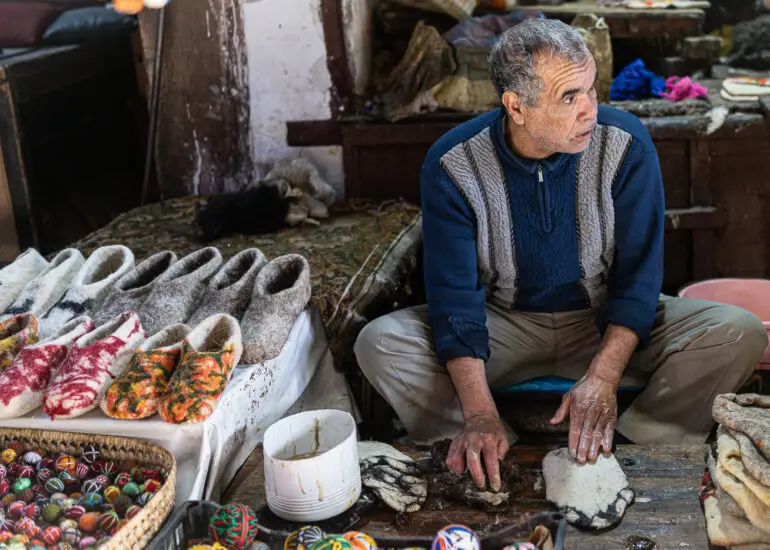 A shoe maker in a souk