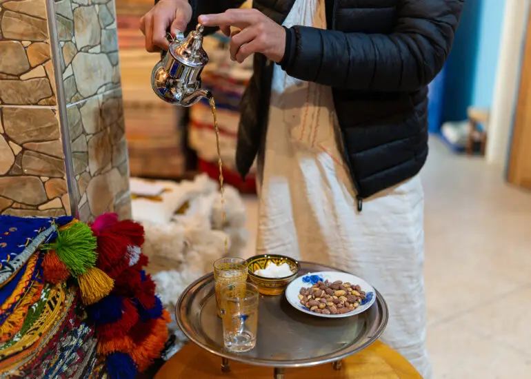Tea being poured for us while we are shopping for rugs in Taznakht
