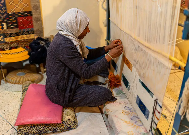 A weaver at a female weaving cooperative in Taznakht