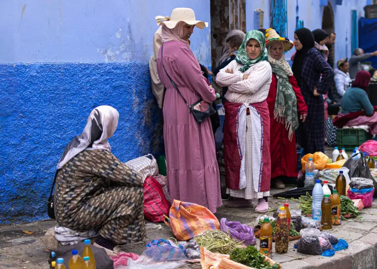 Women selling produce in a market in Chefchaouen